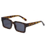 Tortoiseshell rectangular sunglasses with thick frame and dark lenses on white background