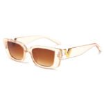 Transparent pink rectangular sunglasses with brown gradient lenses and gold V temple detail