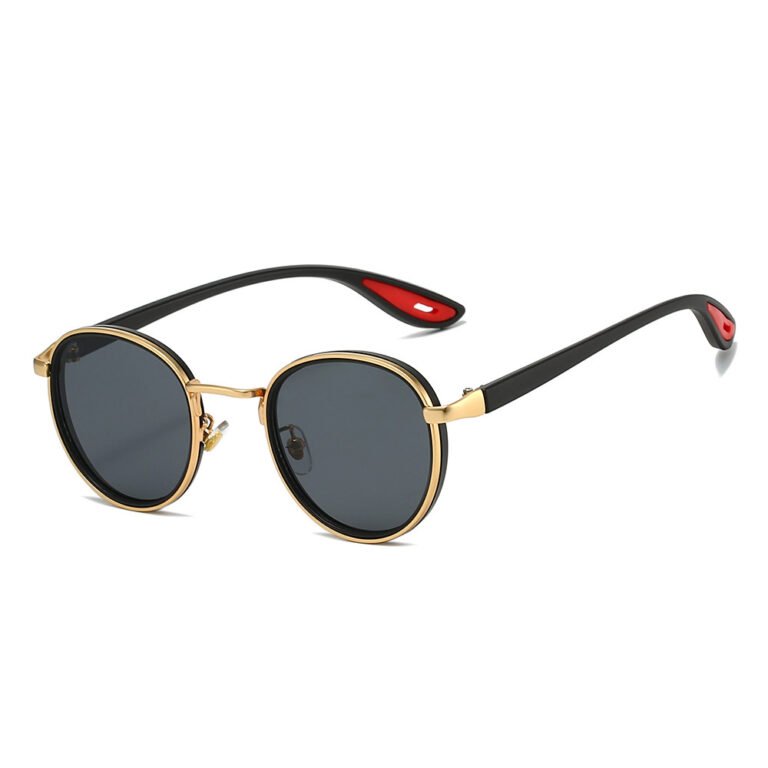 Round sunglasses with black and gold frame, dark grey lenses, and black temples with red inner tips