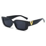 Black rectangular sunglasses with dark lenses and gold V-shaped temple detail