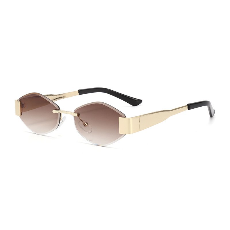 rimless-oval-sunglasses-gold-temples-black-tips-brown-gradient-lenses.jpg Rimless oval sunglasses with gold metal temples, black tips, and brown gradient lenses on a white background