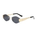 Rimless oval sunglasses with gold metal temples, black tips, and dark grey lenses on a white background