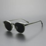 Transparent green round sunglasses with black lenses, minimalist unisex eyewear design